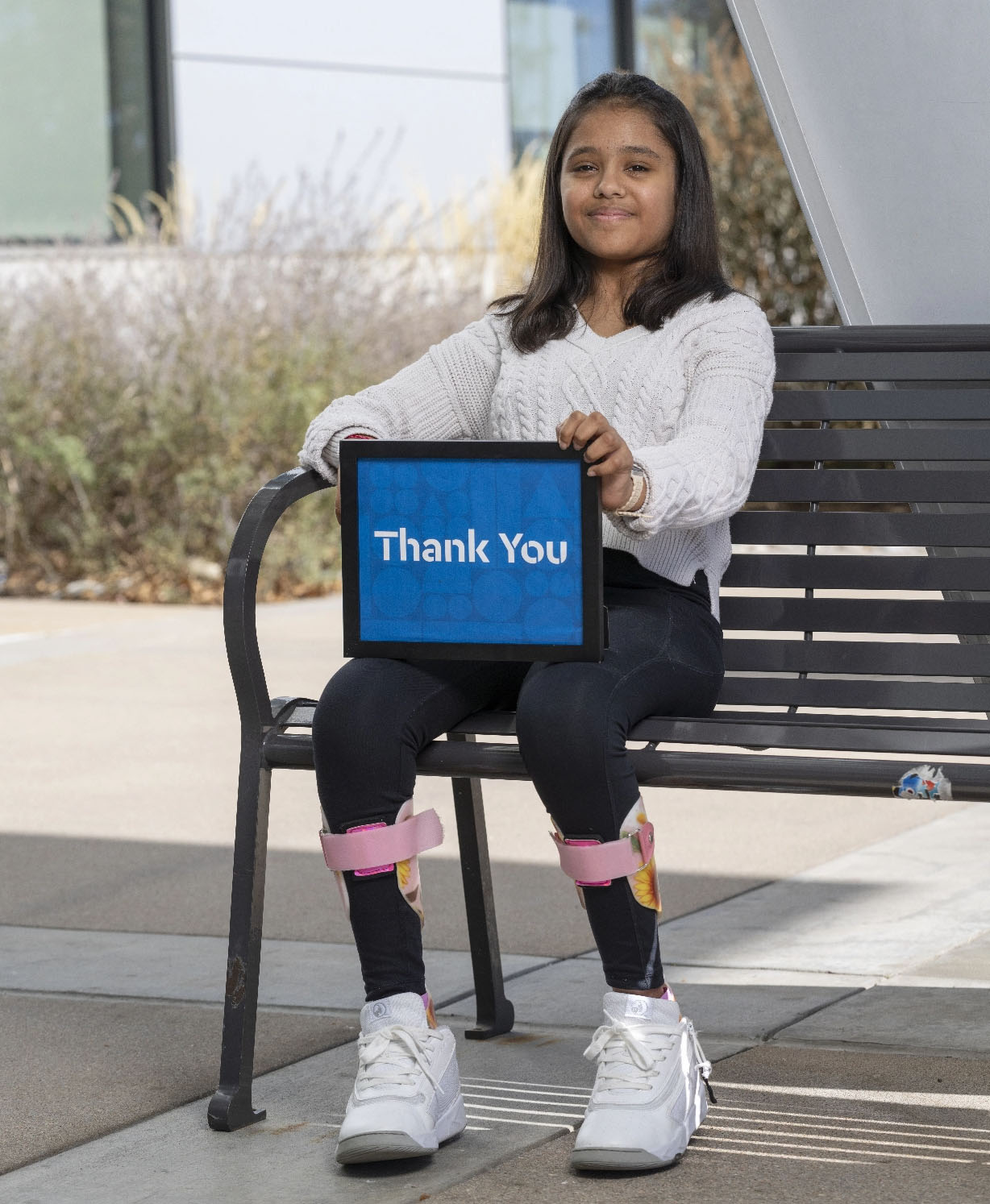 Girl holding thank you sign