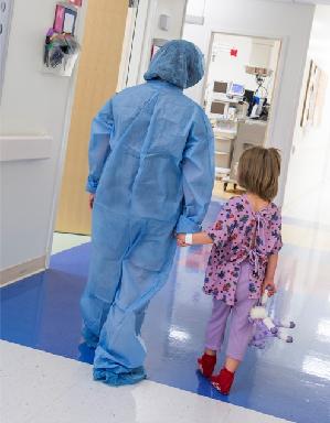 Team member escorting a child to surgery