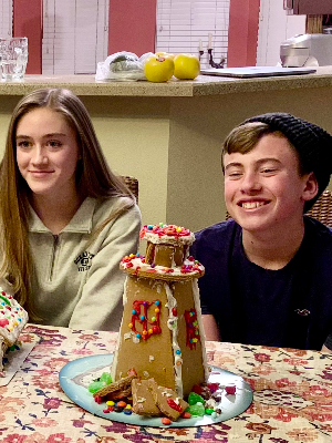 Theo and his cousin making a gingerbread house.