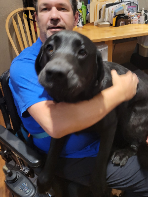 Ryan and his service dog, Couli.