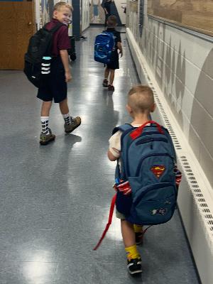 Super Drake escorted in by his big brother's on the first day of preschool