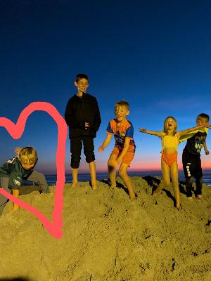 Hawkin playing with Bradley, Abigail, and his two brothers on the beach in San Diego (go Eagles!)