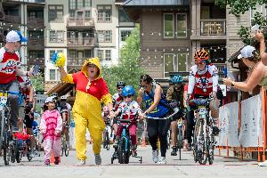 Forest, Children's Hospital Colorado patient crossing the finish line at the 2024 Courage Classic