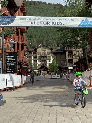 Micah crossing the finish line 2025