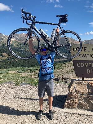 Eli at the top of Loveland Pass during the 2025 Children's Courage Classic!