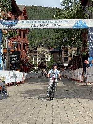 Anna crossing the finish line 2025