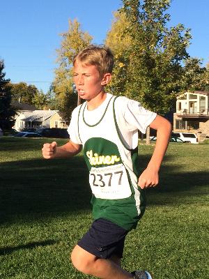 Cooper running in a middle-school cross country meet for Skinner.
